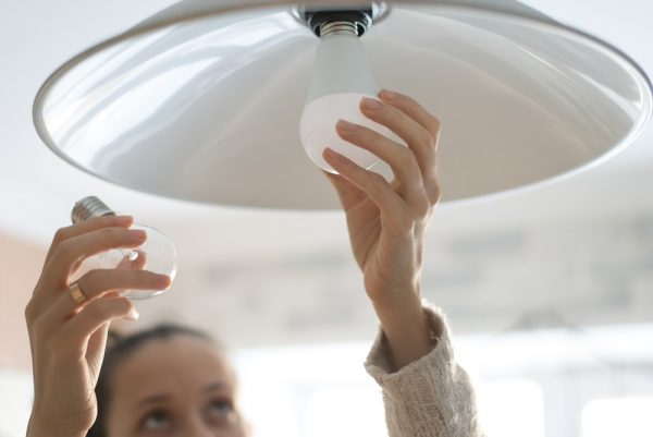 What Should You Know about Buying a Bulb? woman replacing light bulb | Lifestyle
