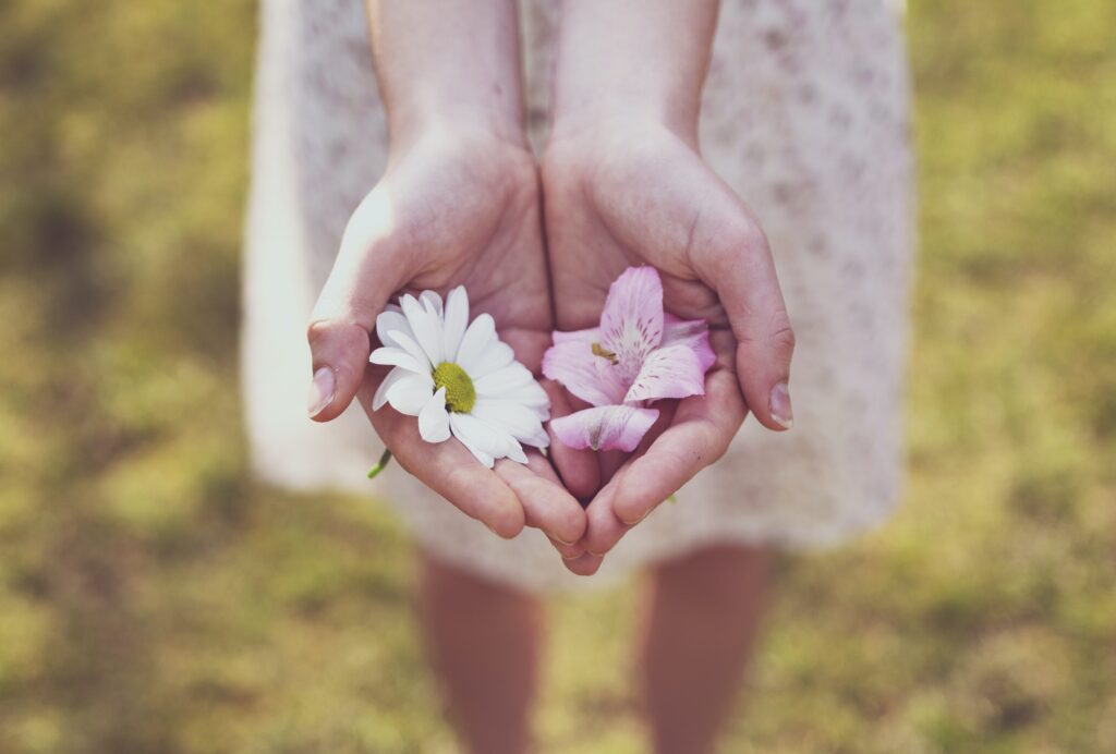 Girl gives the blooms in her hand.